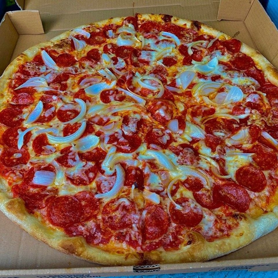 A whole pepperoni and onion pizza from Two Brothers Topping's Pizza in a cardboard box.