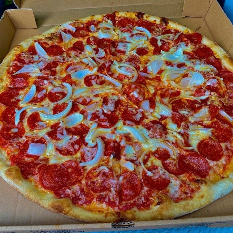 A whole pepperoni and onion pizza from Two Brothers Topping's Pizza in a cardboard box.